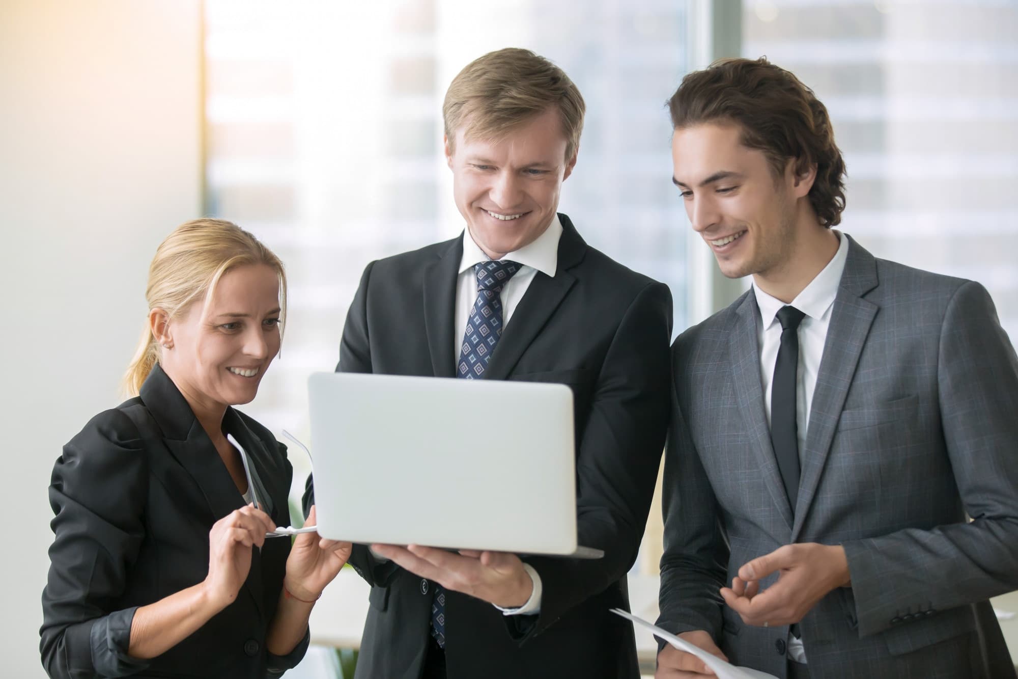 A business team reviewing results together on a laptop
